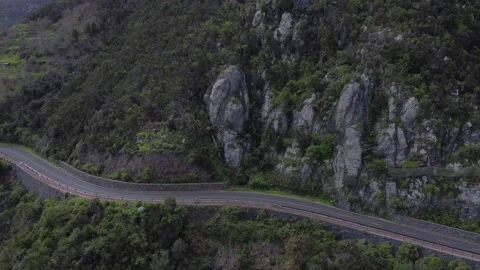 Sky shot of two cyclist next to a green hill, Tenerife, 4K Stock Footage 171714023