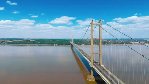 Sky shows bridge stretching over muddy river 스톡 동영상 343522496