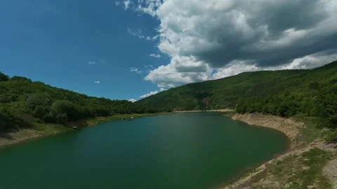 Sky shows fluffy clouds and deep blue. Zavoj Lake, Serbia. Timelapse Stock Footage 337494594