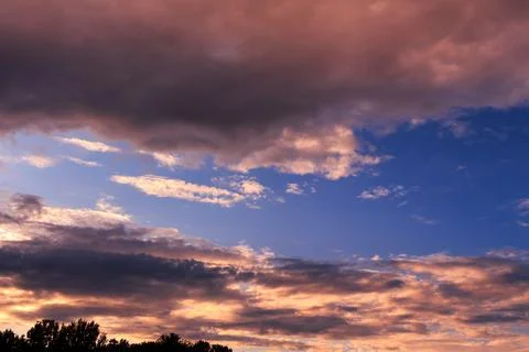 Sky with some dramatic clouds and vibrant colors at golden hour Stock Photos