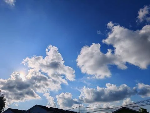 Sky with Sunlight and Rooftops Stock Photos