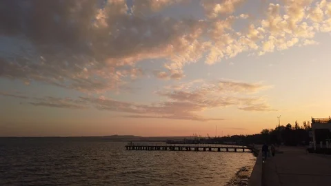 Sky. Sunset. The camera takes a panorama of the sky and descends to the sea. 動画素材 119711583
