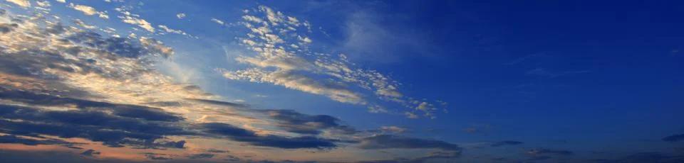 Sky at sunset with dark clouds, panoramic large shot. Background from the c.. Stock-Fotos