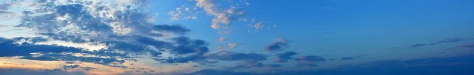 Sky at sunset with dark clouds, panoramic large shot. Background from the c.. Stock Photos