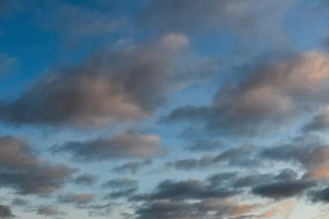 Sky texture with several clouds at sunrise Stock Photos