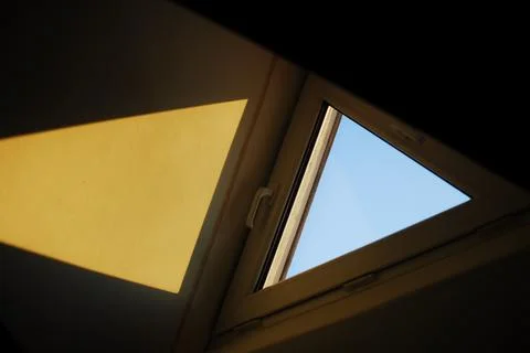 Sky through a window with a yellow triangle in the middle Foto stock
