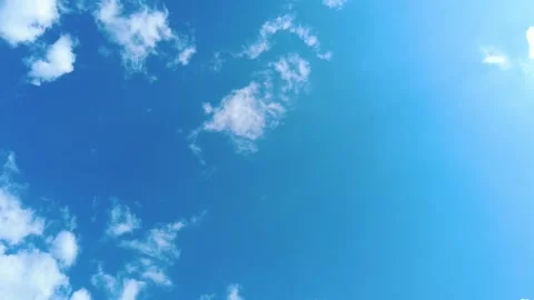 Sky time lapse clouds and blue sunny sky, Loop of white clouds over blue sk.. Stock Footage 241403543