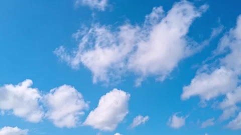Sky timelapse. Moving clouds and sun. White fluffy clouds slowly float through Stock Footage 311563899