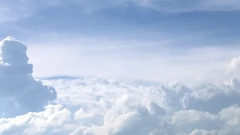 Sky timelapse of soft white clouds drifting across a pale blue sky. Calm Stock Footage 338024317