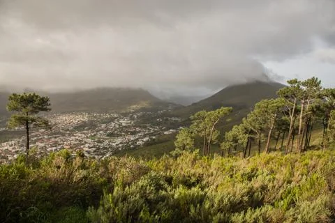 Sky on top of a mountain with clouds over the coast of Cape Town. Stock Photos