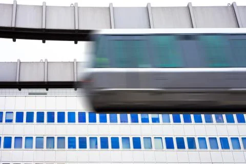 Sky-train passing fast in front of office building Stock Photos