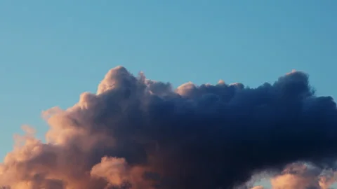 Sky transforms from a brilliant blue to a fiery orange and red as the sun sets Stock Footage 241287615