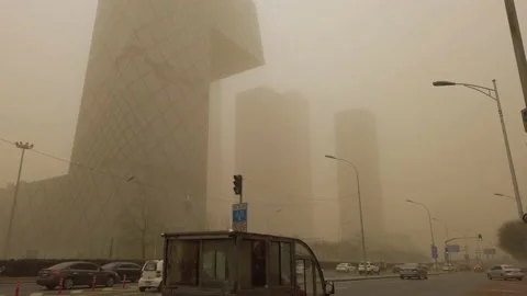 Sky turning orange as sandstorm and pollution hitting the city, Beijing, China. Stock Footage