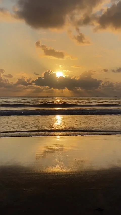 The sky turns yellow as the sun sets by the beach Stock Footage 235482729