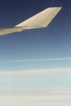 The sky is under the wing. Stock Photos