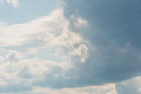 A sky with various cloud formations, dominated by dark cumulonimbus clouds .. Stock Photos