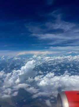 Sky view from airplane window. There were clusters of clouds in the blue sky  Stock Photos