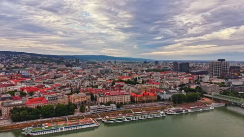 Sky view of the city with buildings, river, and cloudy sky in the background Stock Footage 341380309