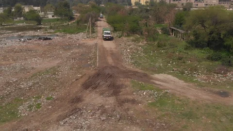 Sky view of garbage disposal trash dump or open landfill, India Stock Footage 128124130