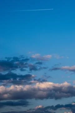 A sky view with a tiny plane leaving a fume mark on it Stock Photos