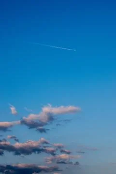 A sky view with a tiny plane leaving a fume mark on it Stock Photos