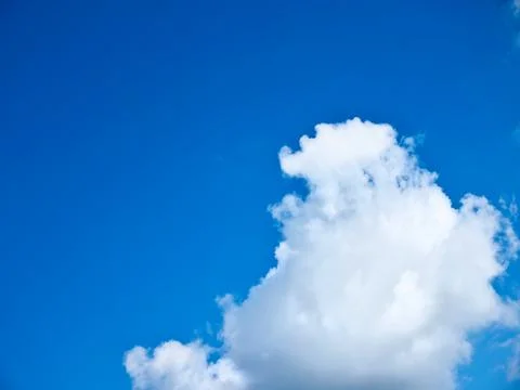 The sky where a white cloud comes in from below Stock-Fotos