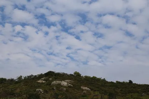 In the sky, white clouds form beautiful patterns in blue and gray colors ab.. Fotos Stock