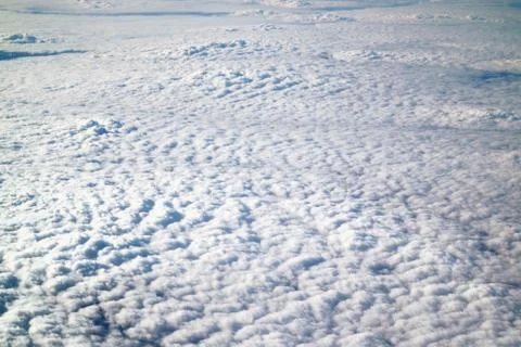 Sky white clouds view from the plane as the background. Stock Photos