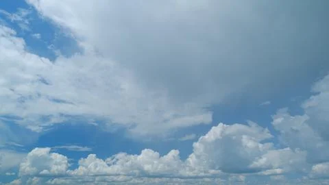 Sky with white fluffy rain clouds on the blue sky. Dramatic cloudscape, amazing 写真素材