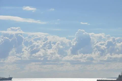 Sky with wild clouds reflected on them by the sun Stock Photos