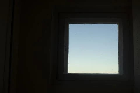 Sky is in window. Backlight from window. Light square on dark background. Stock Photos