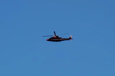 Skybound Elegance: Helicopter Soaring in a Blue Sky Stock Photos