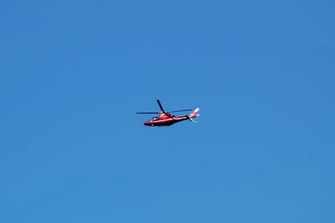 Skybound Elegance: Helicopter Soaring in a Blue Sky Stock Photos