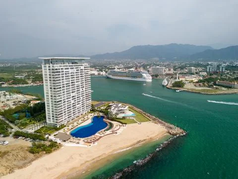 Skycraper by Bay Shoreline with Pool Beach Resort by Cruise Yacht Terminal Pier Stock Photos