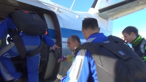 Skydive Team boarding plane. Skydiving Group is preparing to flight Stock Footage 105424845