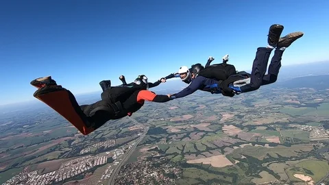 Skydive team formation clear sky slow motion Stock Footage 112608604