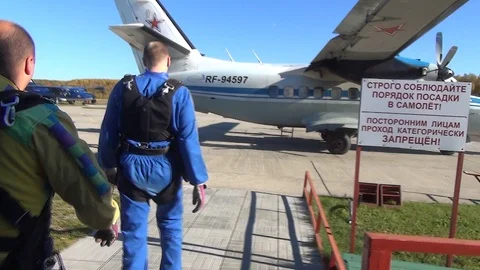 Skydive Team going to plane. Skydiving Group is preparing to jump Stock Footage 105424880