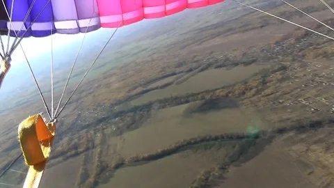 Skydiver doing acrobatic stunt on parachute Stock Footage 105424928