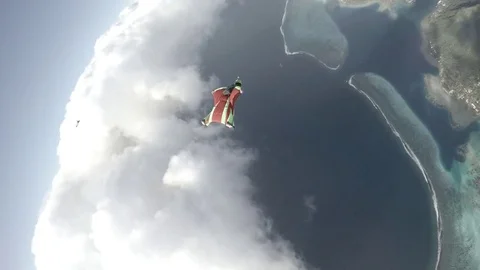 Skydiver Flying Over Coast and Clouds Stock Footage 79735522