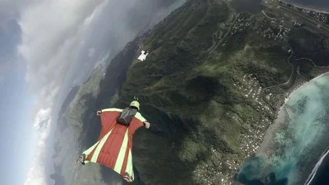 Skydiver Flying Over Coast and Clouds 2 Stock Footage 79735537