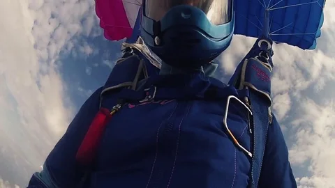 Skydiver in helmet parachuting in sky. Clouds. Extreme hobby. Speed. Flight Stock Footage 79512871