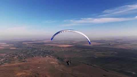 Skydiver hovers weightless above the ground after taking off from the fields. A Stockbeeldmateriaal 267966768