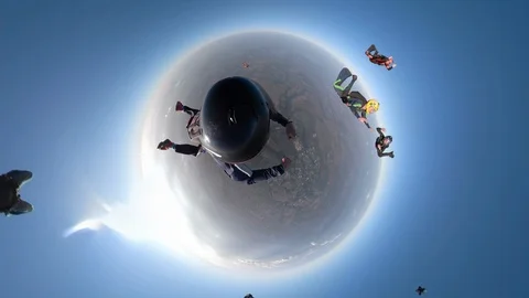 Skydiver jumps in a free fall formation with a 360 degree camera Stock Footage 120955644