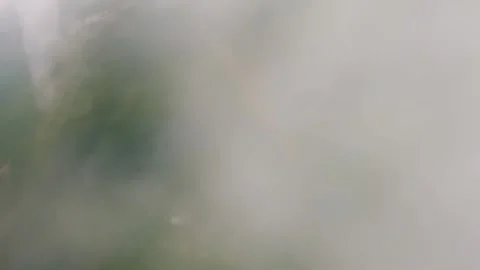 Skydiver in jumpsuit pilots through thick clouds above Earth Stock Footage 236578312