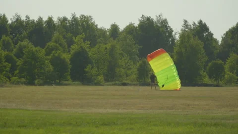 Skydiver Landed On An Open Ground With Parachute. wide Stock Footage 247107768
