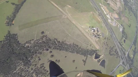 A skydiver looks at her altimeter while parachuting. 스톡 동영상 68010316