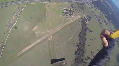 A skydiver looks at her altimeter while parachuting. Stock Footage 68010348