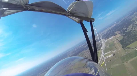 A skydiver looks at her altimeter while parachuting. 스톡 동영상 68573019