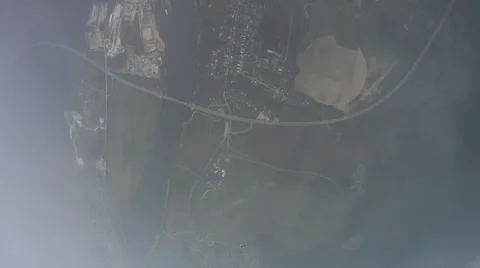 Skydiver open parachute in sky. Fly in clouds above green field. Extreme Stock Footage 65797459