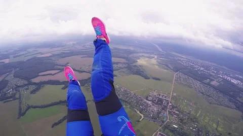 Skydiver opens parachute, fly above green fields. High altitude. Extreme sport Stock Footage 64239137